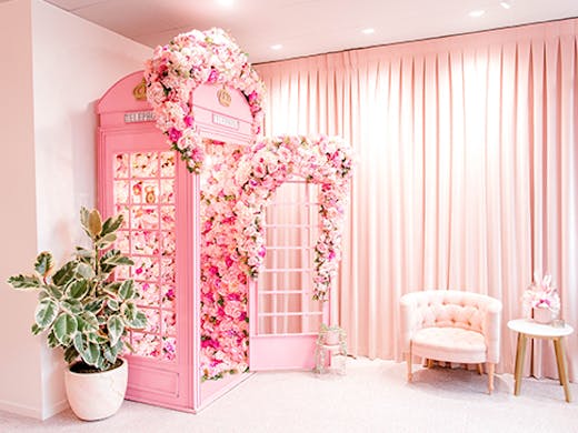 The famous pink vintage phone booth with cascading flowers at The Lash Spa.