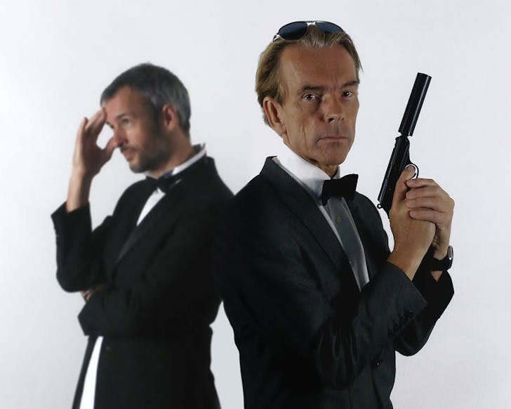Two people in James Bond outfits.