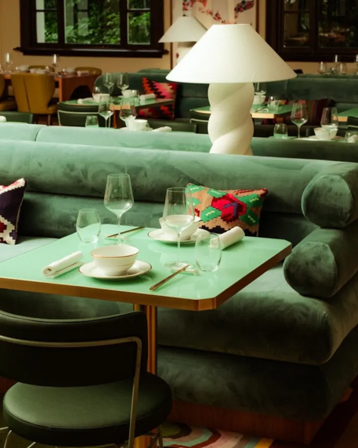 Green couch and chair with white lamp 