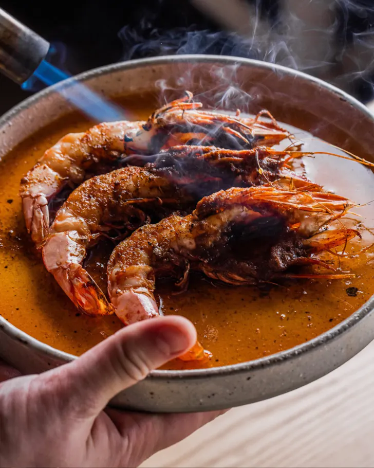 Three grilled prawns on a plate