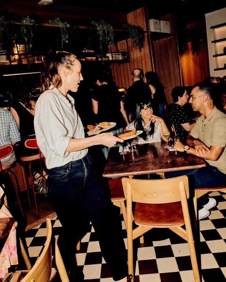 Person serving on checkered tile floor