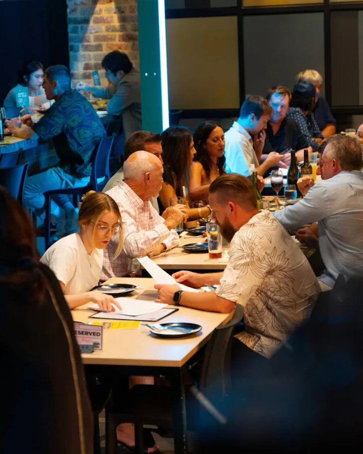 Person at table writing down on paper