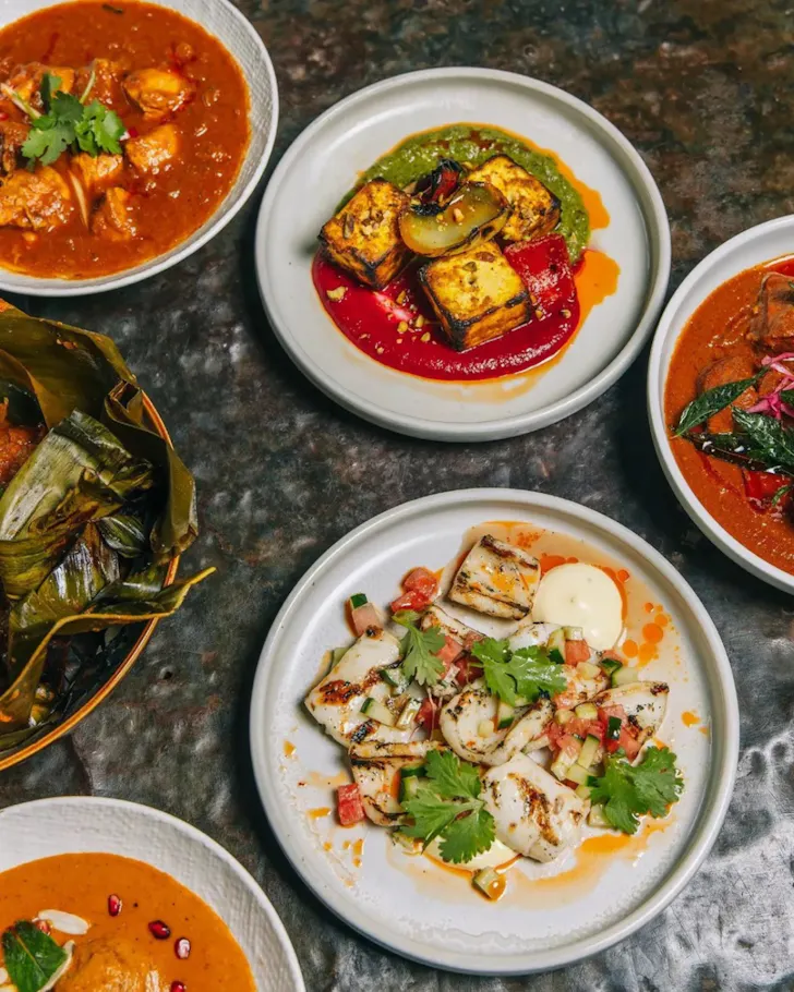 Five plates of vibrant coloured curries