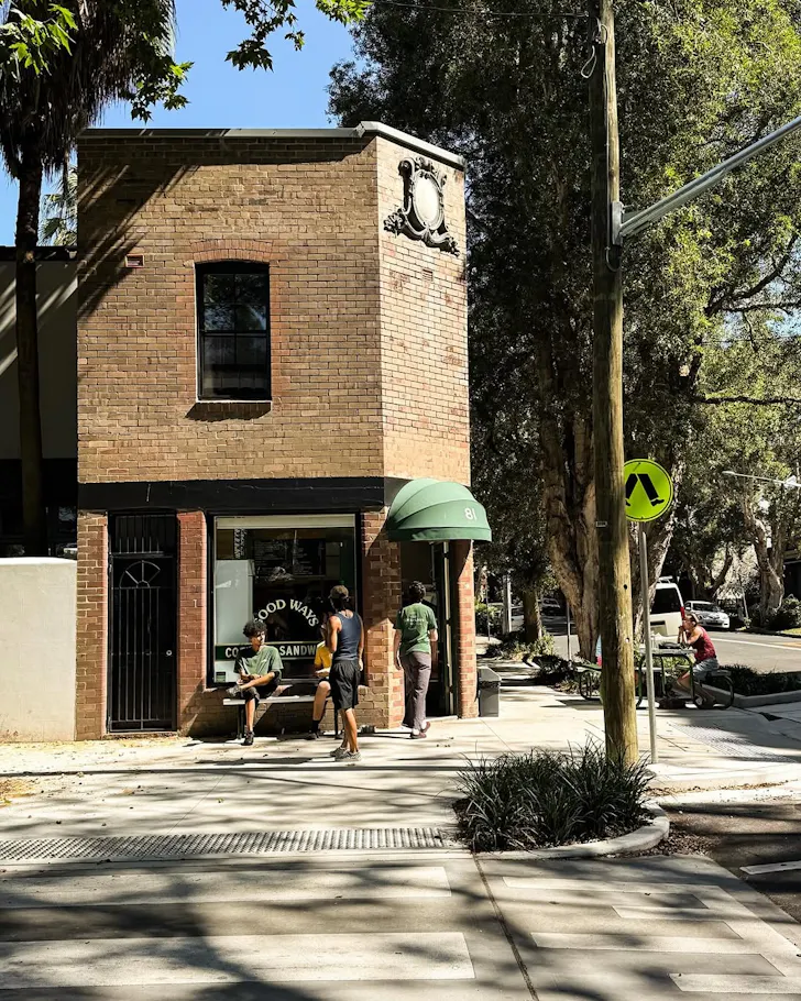 Brick shopfront with person walking
