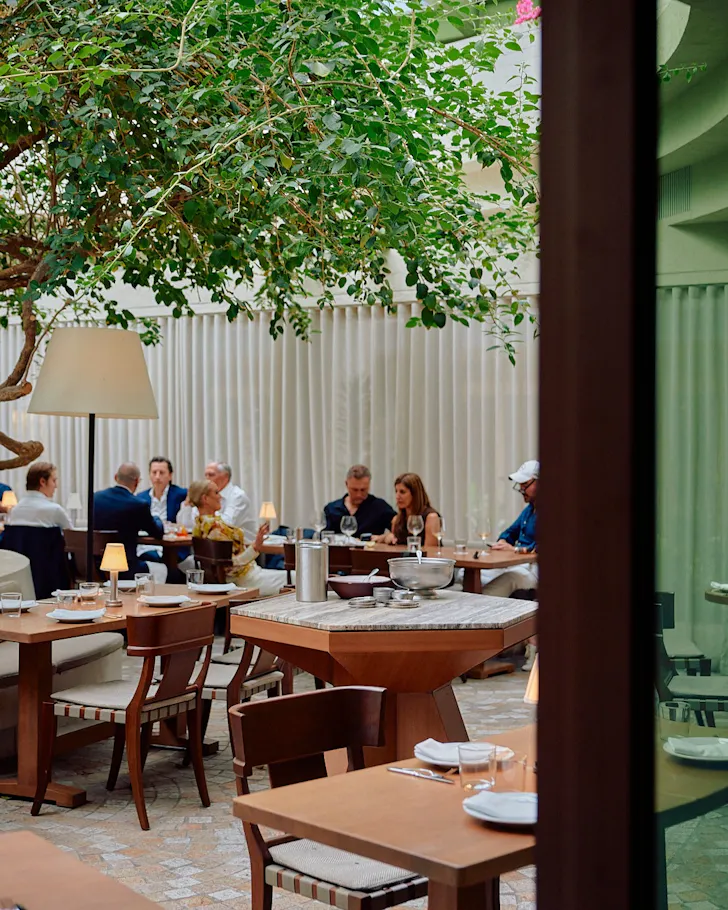 Green dining area with people sitting at tables