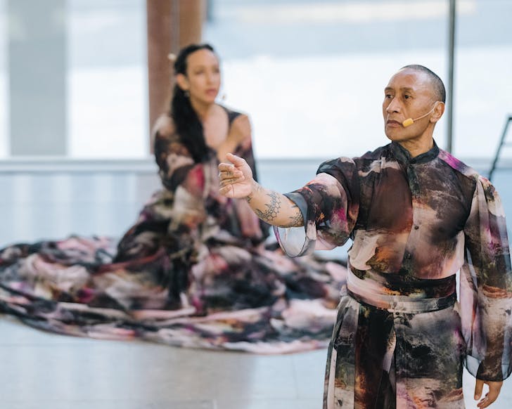 Two dancers in intriguing long flowing dyed garments mid-performance.