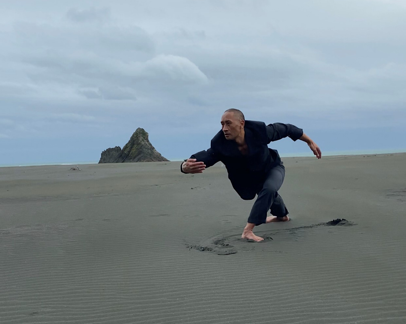 Renowned choreographer and dancer Taane Mete performs Pōhutukawa, a work he created especially for Matariki, on a beach.