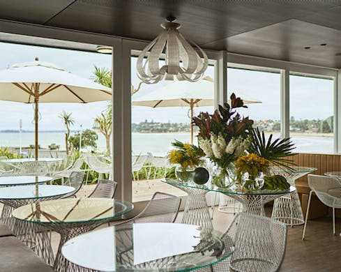 Chic interiors and a beach view at Takapuna Beach Cafe. 
