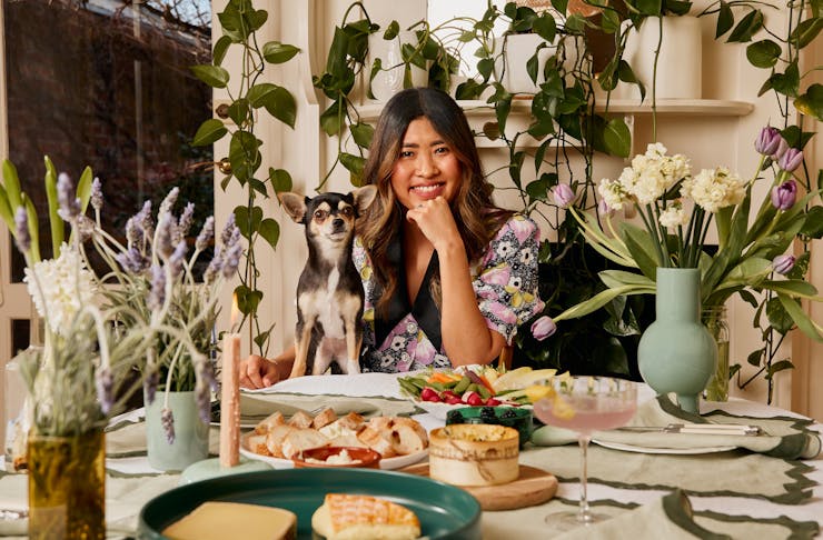 Jess Nguyen sits at her stunning table with her dog, Pabla.
