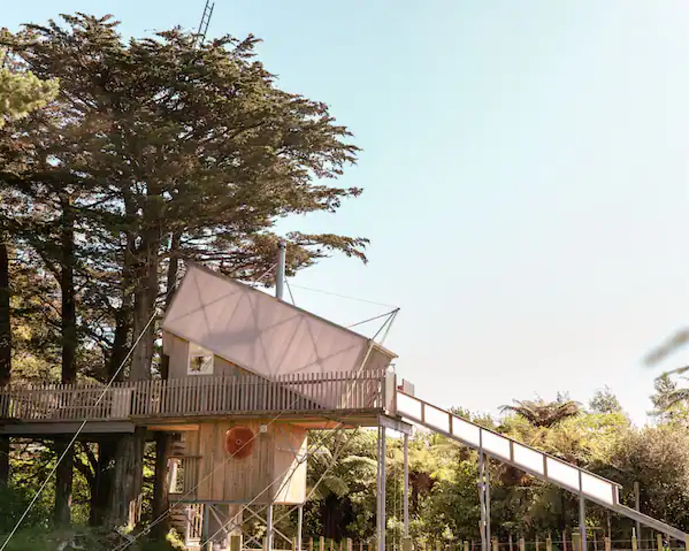 An unbelievable four-storey treehouse with an attached slide. 