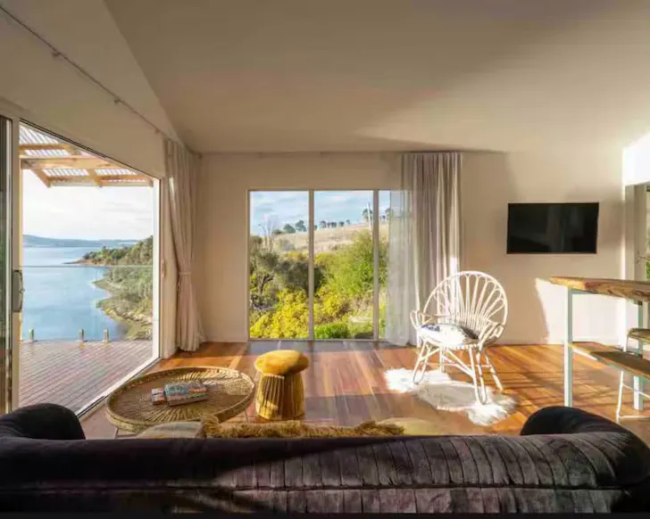 A view of the living space with a sea view at Tassie Wild one of the best Airbnbs in Hobart
