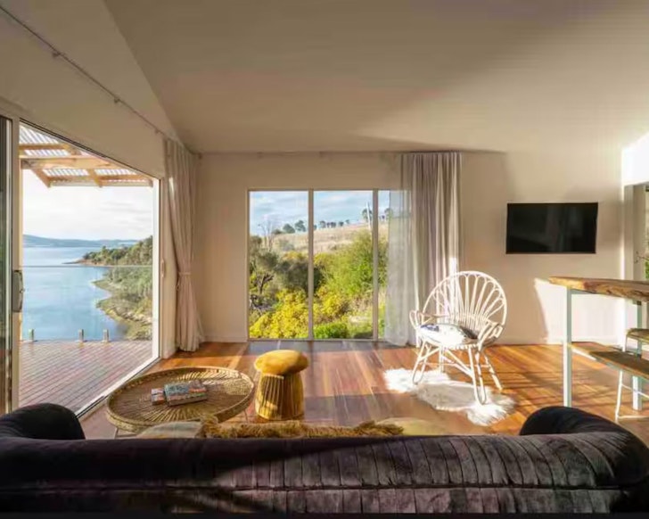 A view of the living space with a sea view at Tassie Wild one of the best Airbnbs in Hobart