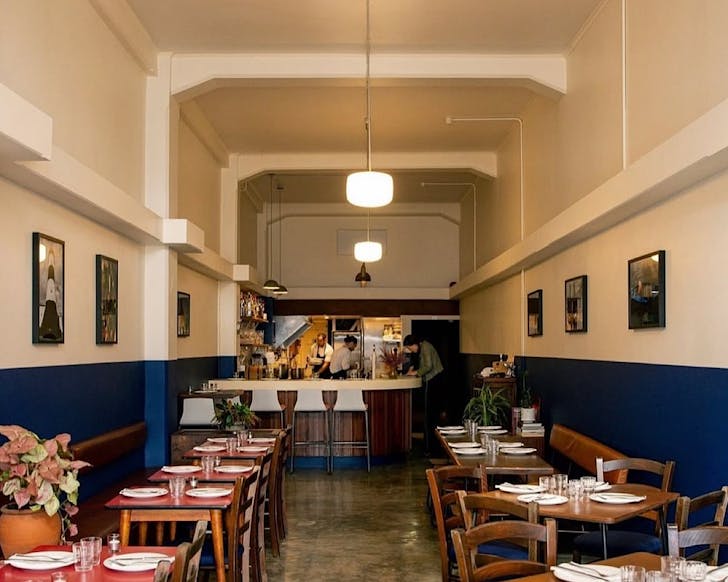 A restaurant with dark blue and white walls. 