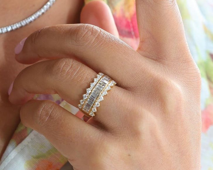 A close up of a Temple & Grace diamond wedding band on a woman's hand