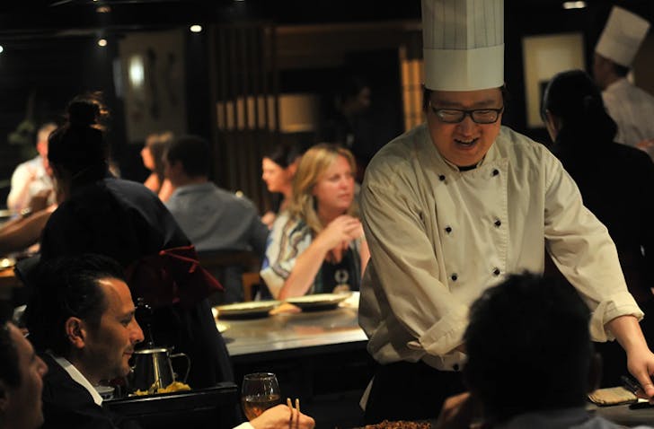 A master Japanese chef is cooking excellent dishes right in front of diners at a Melbourne best Japanese restaurant.