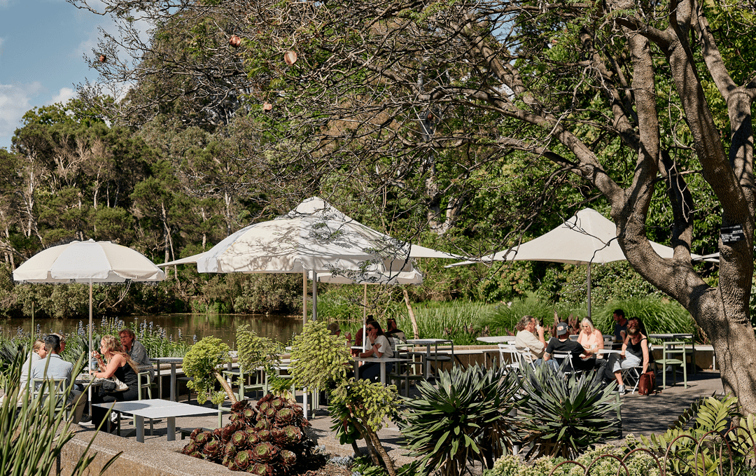 A group of umbrellas in an outdoor dining with trees, one of the best things to do in Melbourne.