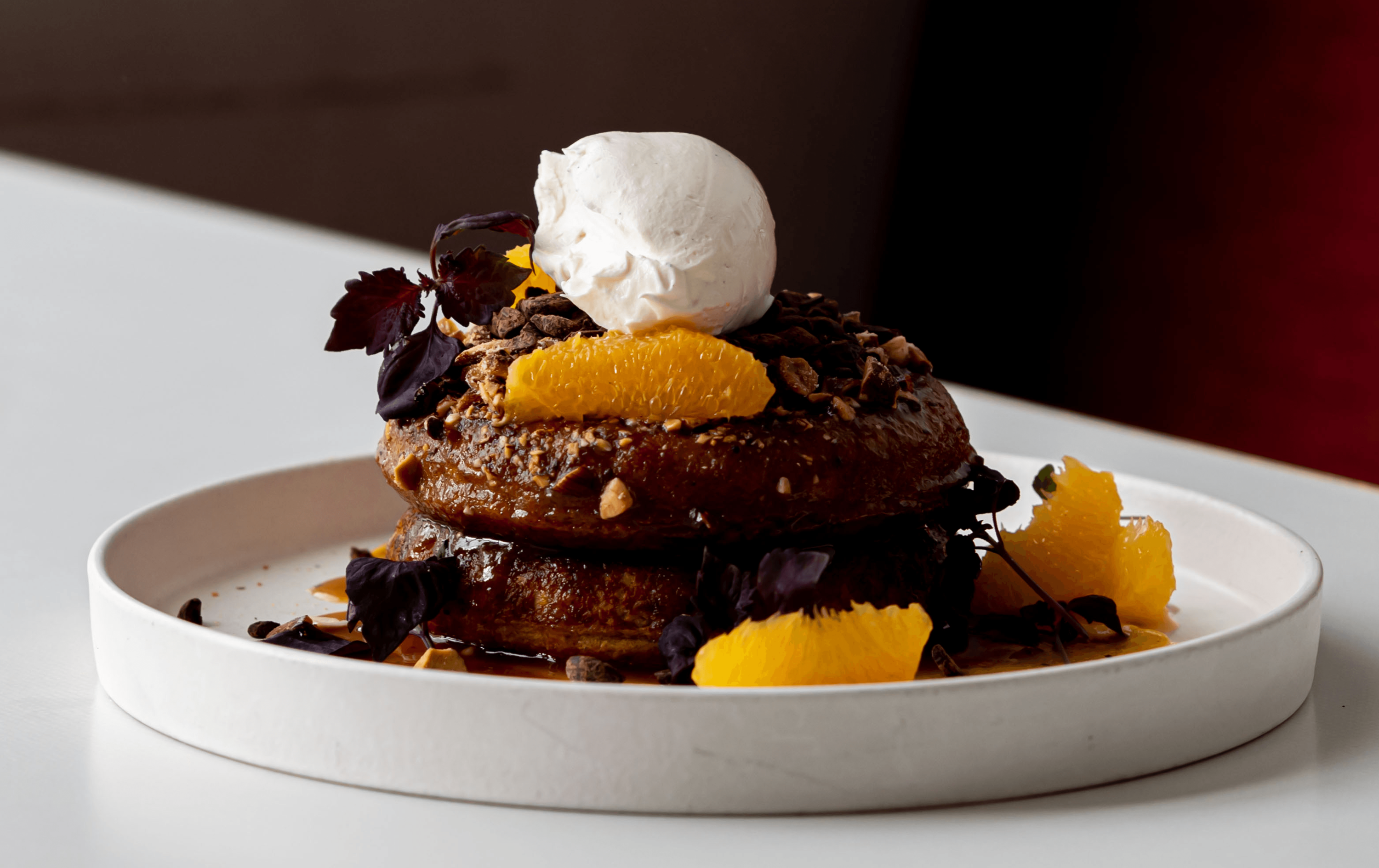 A mountain of chocolate fluffy pancakes topped with fresh fruit and nuts—one of the best breakfasts in Melbourne at Terror Twilight