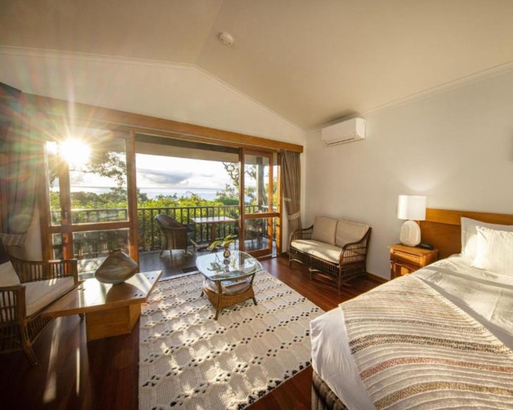 A bedroom looking out to nature at Thala Beach Nature Reserve one of the best luxury resorts in Queensland