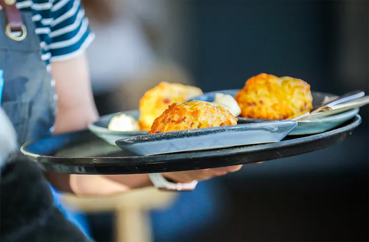 Someone brings scones to the table at the Batch Cafe in Invercargill.
