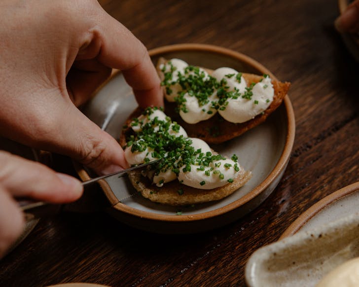 person cutting into dish