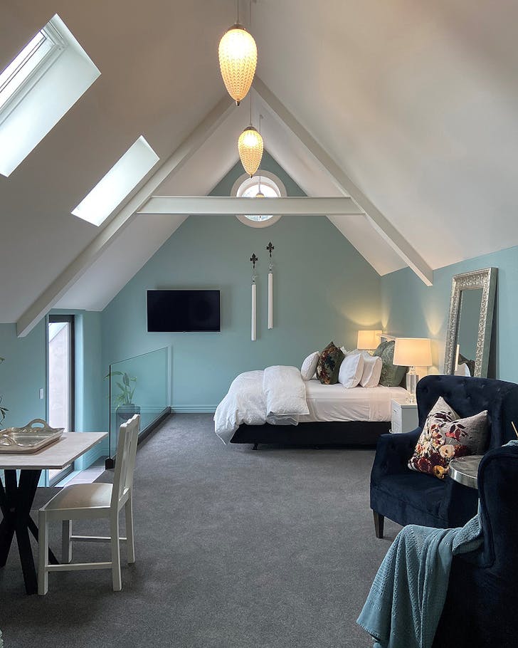 A cosy bedroom with vaulted ceilings at The Church 1914, one of the best places to stay in Invercargill.