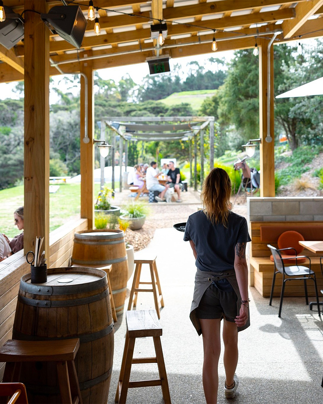 A server walks to an outside table at The Heke, one of the best restaurants on Waiheke.