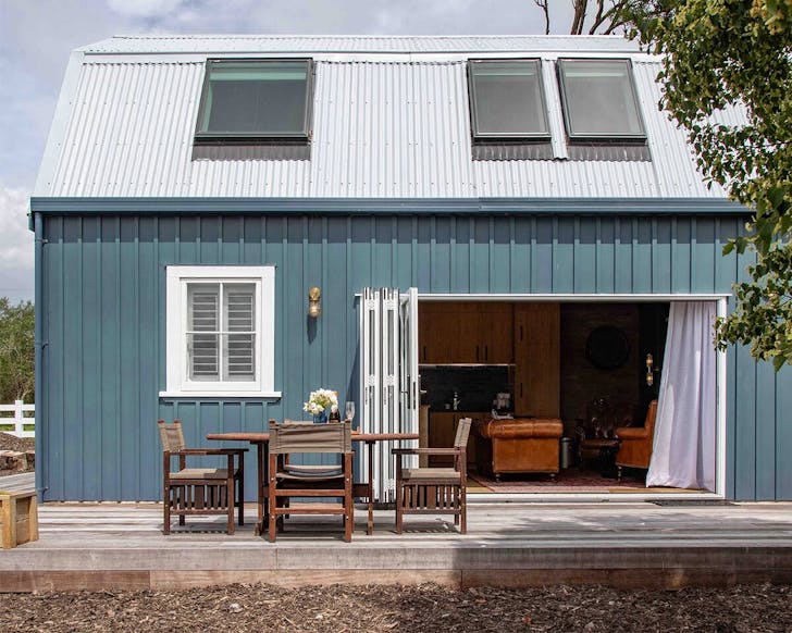 A blue barn in a field, one of the best weird and wonderful places to stay in New Zealand. 