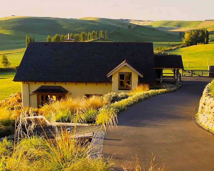 A cute cottage looks out onto farmland in Invercargill.