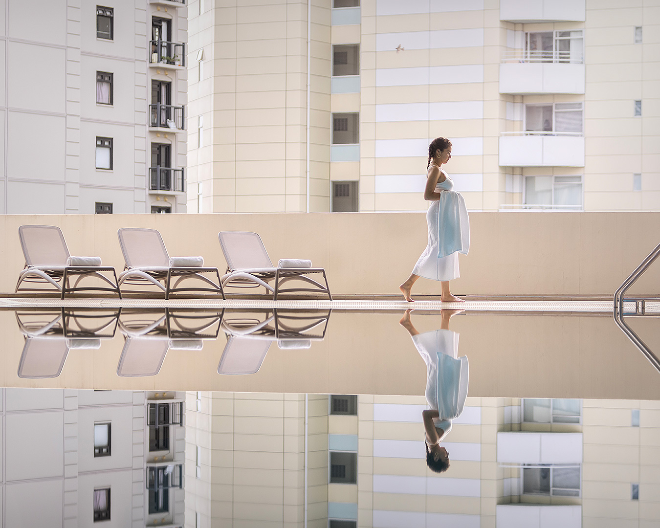 Someone walks by the pool at The Pullman hotel in Auckland, one of the best hotels in Auckland.