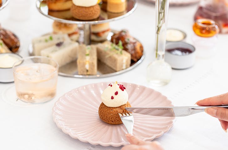Someone cutting into a little cake as part of The Terrace's High Tea for Mother's Day in Melbourne 2024