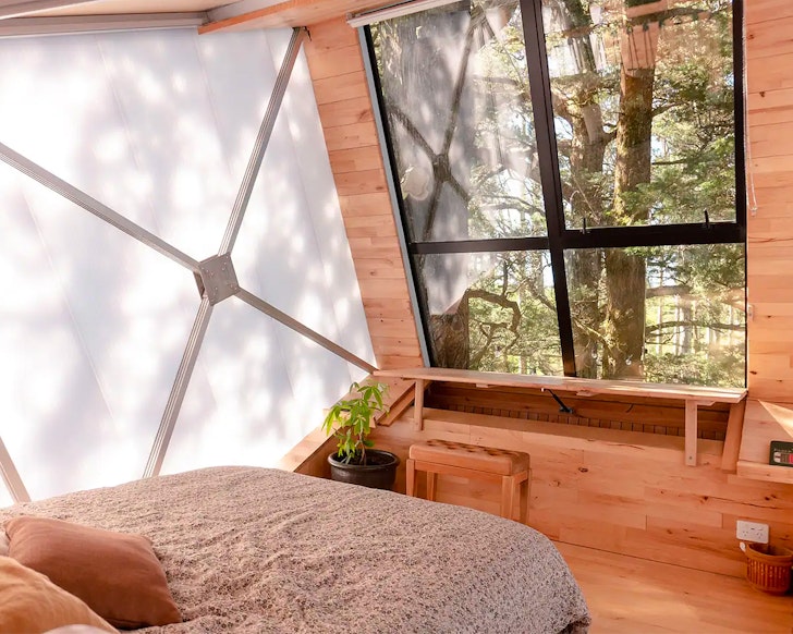 The bed with a view at The Treehouse: Off-Grid Retreat
