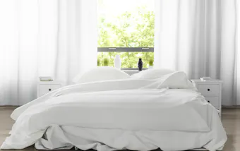A white-sheeted double bed.