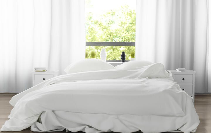 A white-sheeted double bed.