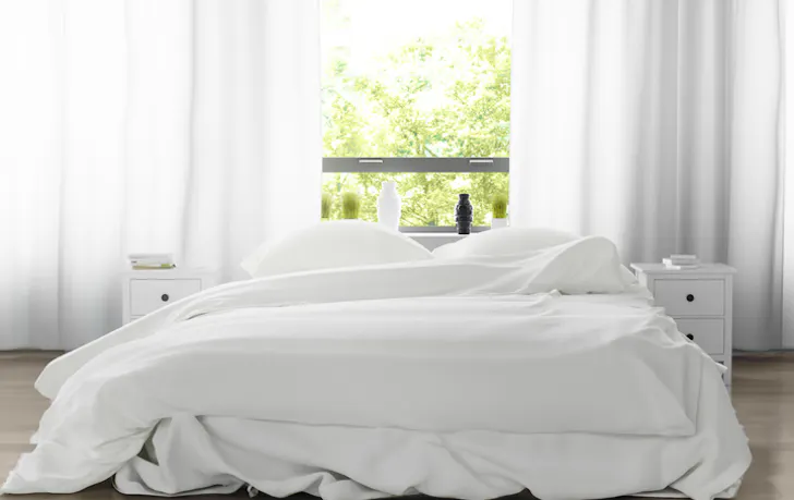 A white-sheeted double bed.