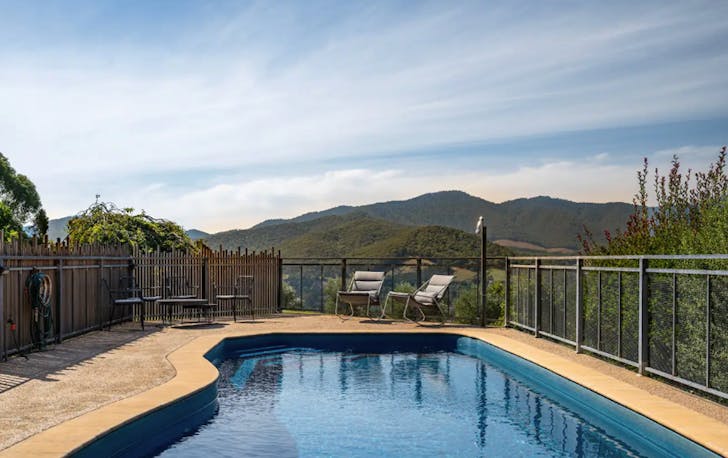 A pool overlooking a valley at one of the best farm stays in Victoria.