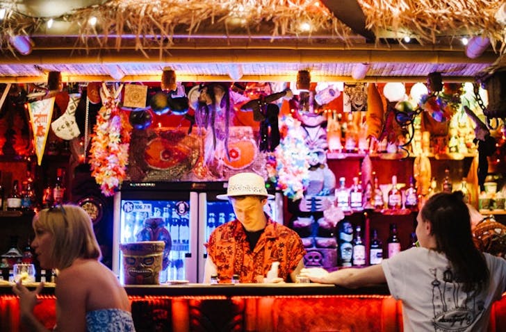 A bartender in a Hawaiian shirt at one of the best cbd bars Melbourne.