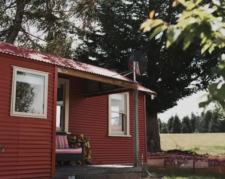 The red exterior of The Red Hut one of the best accommodation options inLake Tekapo New Zealand