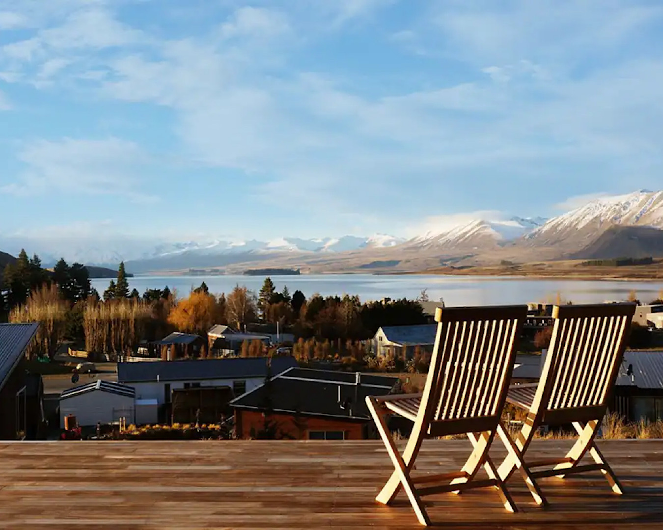 Two deck chairs on a slab deck overlooking a jaw-dropping view of Lake Tekapo. 