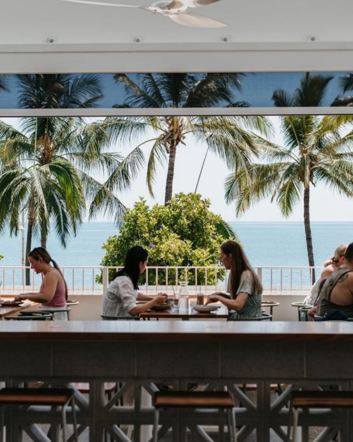 Friends having drinks and dinner overlooking the Coral Sea at The Beach Hotel in Townsville.