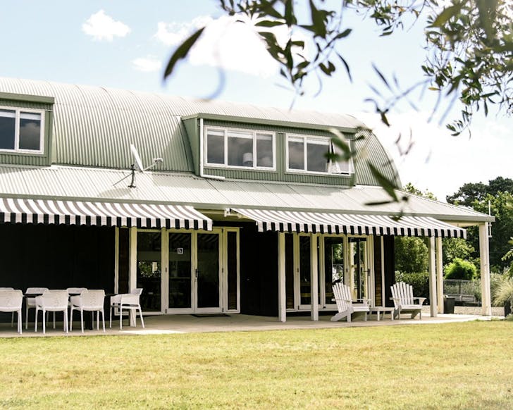 A stripey-canopied building with deck chairs