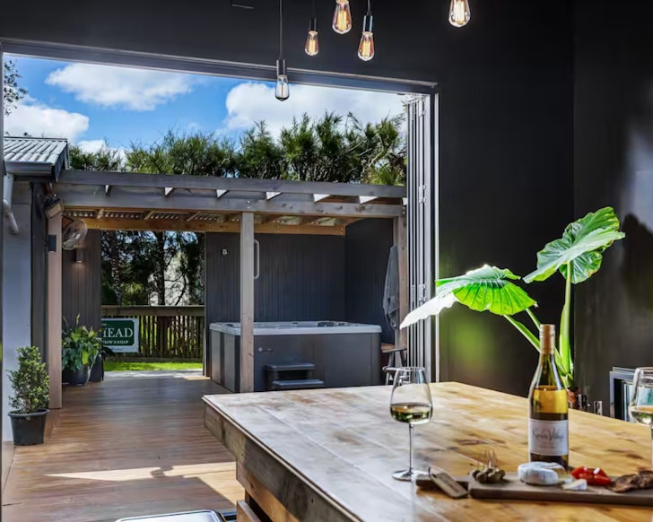 The hot tub and entertaining area at The Black Barn one of the best romantic stays near Auckland