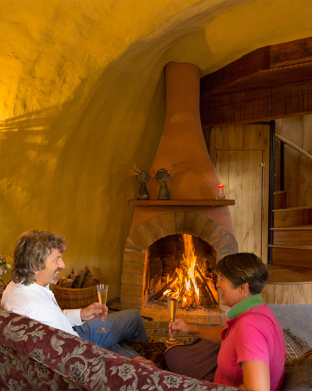 Two people enjoy a roaring fire at The Boot in Nelson, which has two open fireplaces.