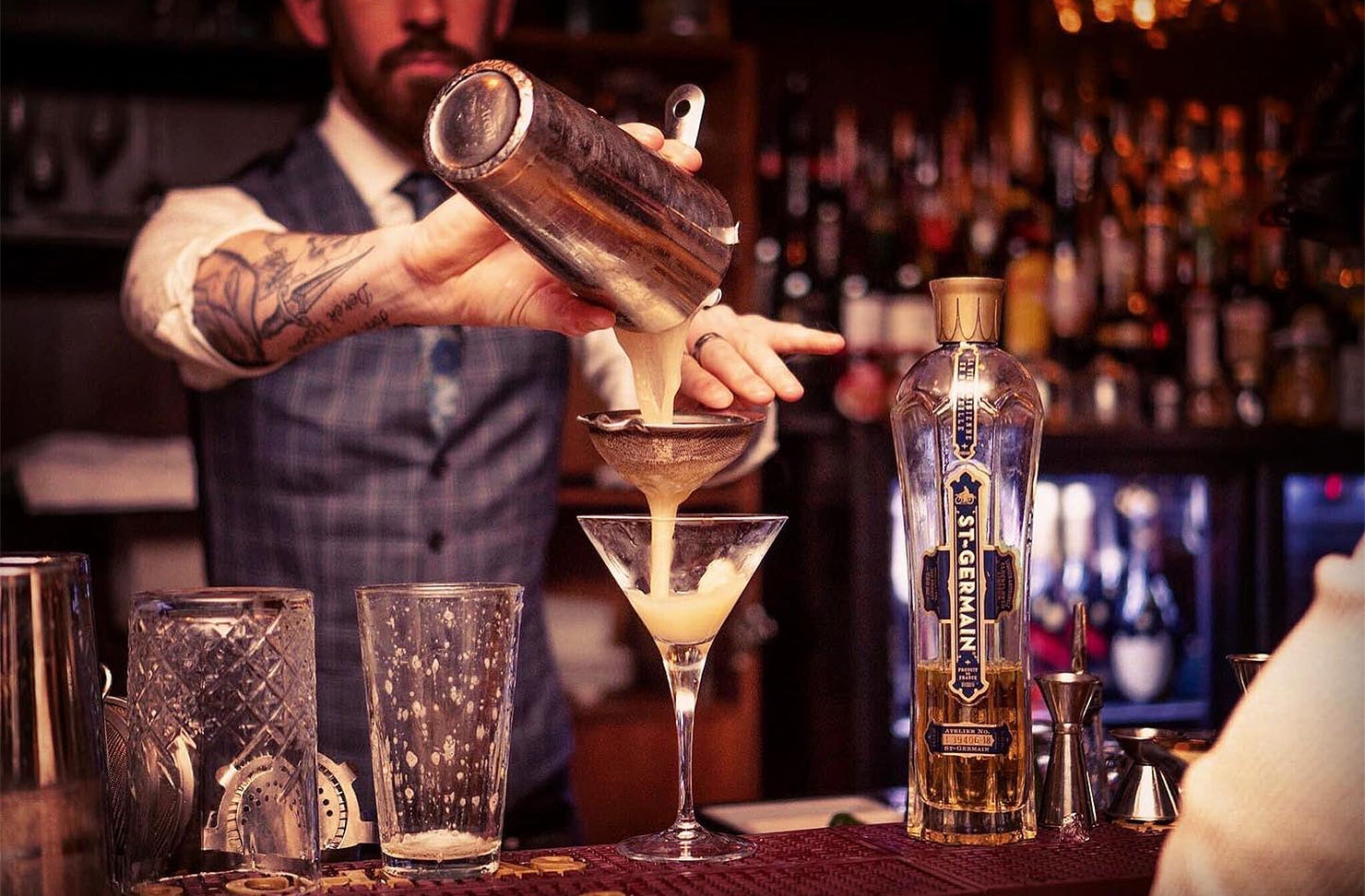A bartender expertly makes a drink at The Bunker, one of the best bars in Queenstown.