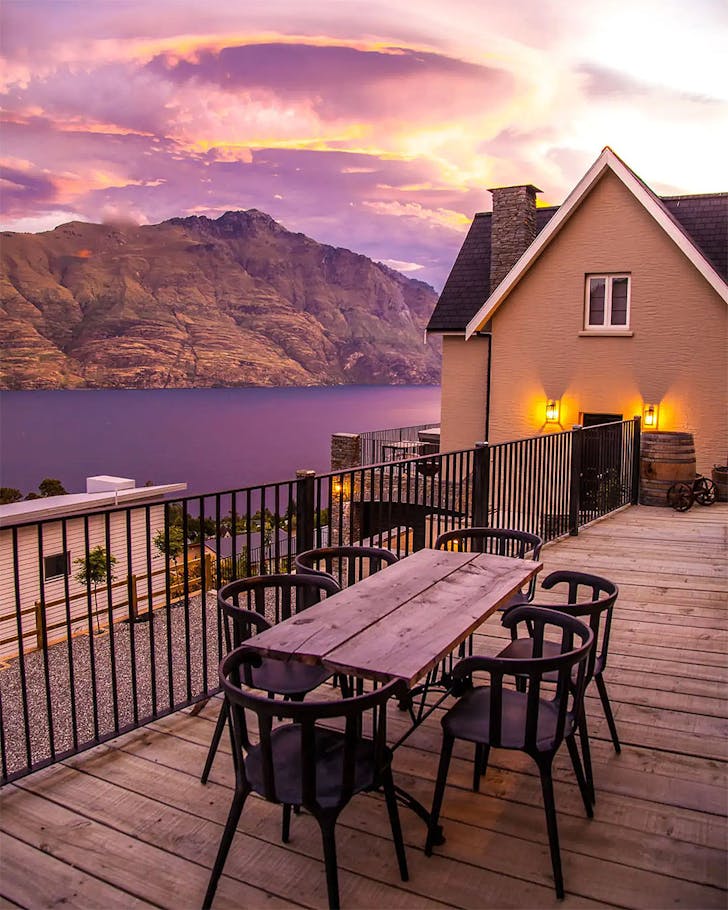 A deck is seen at dusk under a brilliant purple-hued sky.