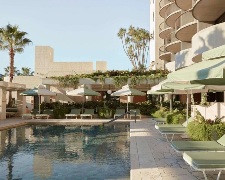 Mint green umbrellas around the pool at The Calile Hotel one of the best romantic getaways in Australia