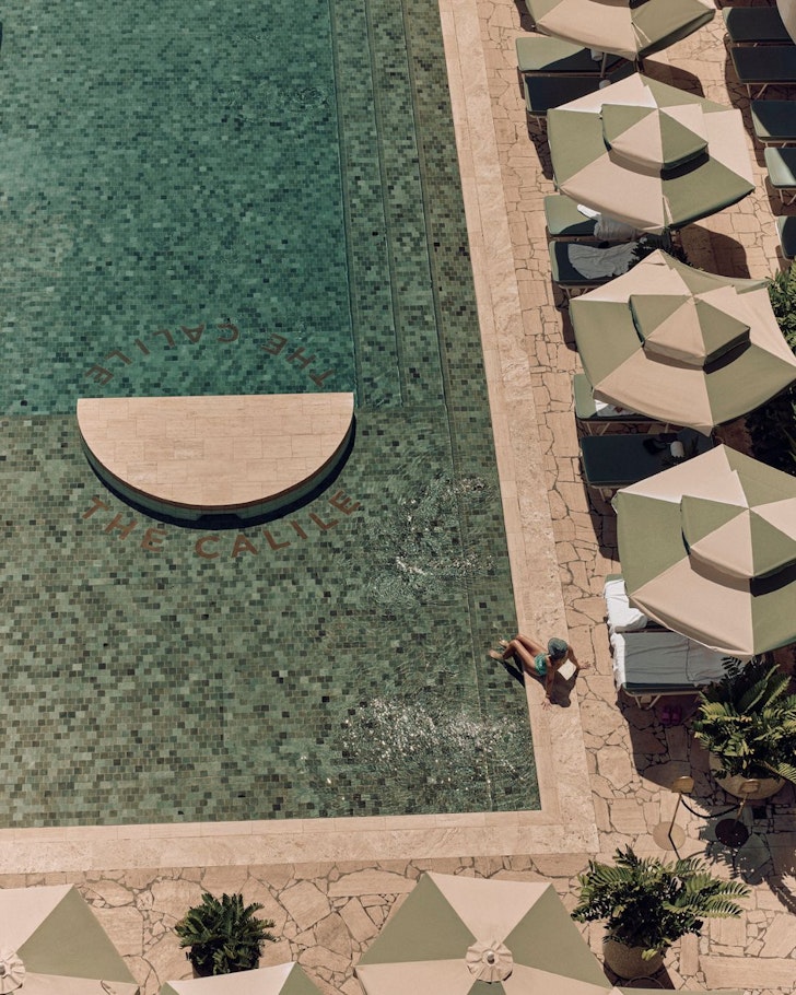 An aerial view of the luxe pool at The Calile surrounded by umbrellas, one of the best hotels in Australia