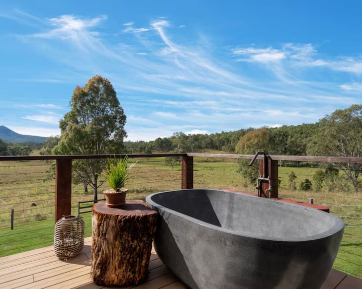 The outdoor bath with a countryside view at The Chalet @ Darclo Farm Airbnb near Brisbane Queensland