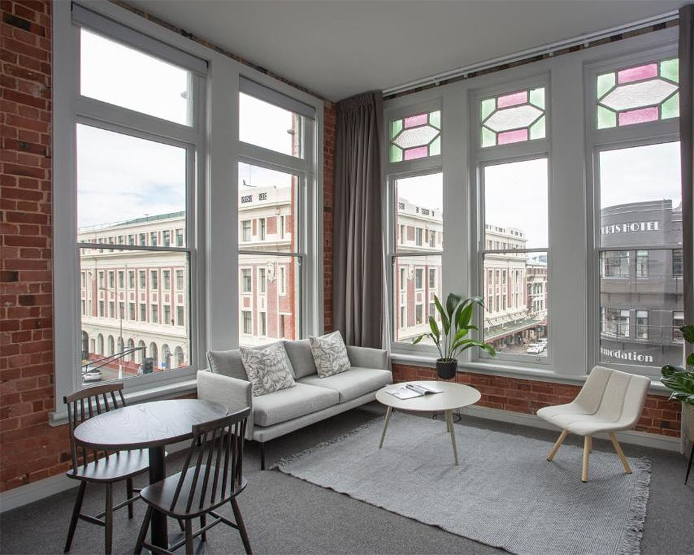 A well appointed sitting room looks out over the heritage buildings of Dunedin.