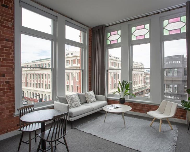 A well appointed sitting room looks out over the heritage buildings of Dunedin.