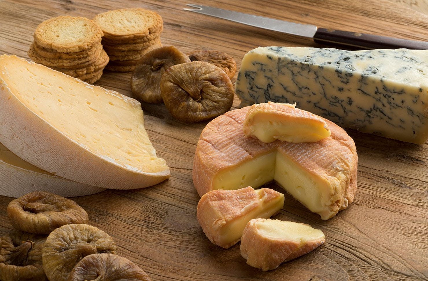 A lovely selection of cheese for delivery sits on a breadboard at The Cheese Wheel.